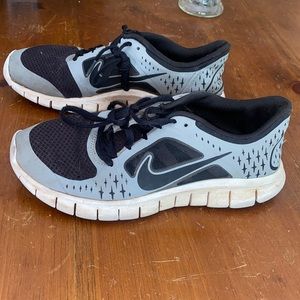 Very worn Nike tennis shoes